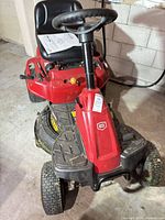 Front three-quarter view of red Craftsman riding mower showing steering wheel, hood, 30" deck and overall cosmetic condition