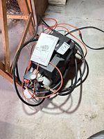 Full view of compressor with hose and manual on top