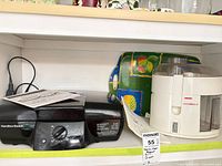 Hamilton Beach grill, Singer juicer and patterned tray on shelf