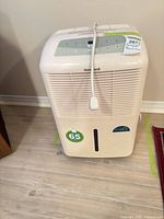 Front view of Honeywell HDH-165 dehumidifier showing controls, grille, power cord, capacity sticker