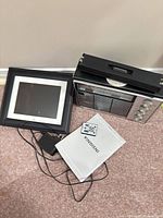 Digital photo frame, radio, remote, adapter and manual grouped