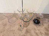 All six glass vases grouped on carpet