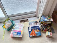 Group shot of all items laid out: games, books, pencils, organizers, chalk