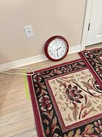 Rugs and clock against wall shows design and size context