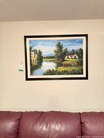 Full view of framed landscape print on wall above sofa