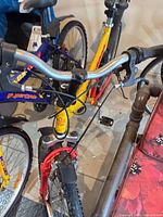 Handlebar and front suspension fork of yellow/red MBX-5000, showing condition