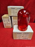Five boxed Appleton V-660-R red glass globes, one unboxed for view