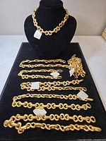 Full lot view showing necklaces on bust and bracelets laid on tray