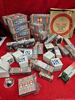 Entire lot showing assorted boxed light bulbs on red background