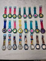 Entire collection of 24 watches laid out in four rows