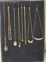 Overall view of eight necklaces on black display board
