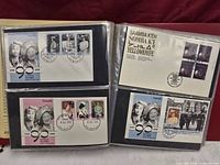 four first day covers in album sleeves showing Uganda UPU, Yellowknife Indigenous languages, Germany UPU and Uganda cathedral themes