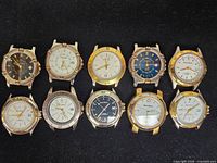Ten Hugo Maxx watch heads arranged in two rows on black background