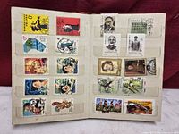 First album spread with 24 cancelled Chinese and Canadian stamps