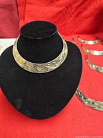 Collar necklace on display bust showing engraved pattern