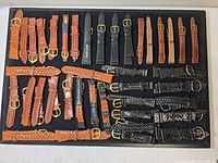 Full board showing assorted brown and black braided leather watch straps