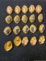 Front view of all 20 cameo clip-on earrings arranged in rows