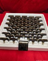 Styrofoam tray holding 55 clock movements