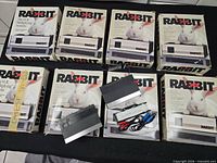 Eight boxed Rabbit TR-7000 systems with two modules and cables displayed