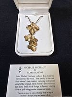 Necklace in opened presentation box with card