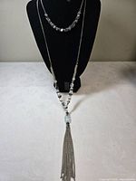 Full view showing both strands and tassel pendant