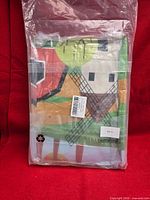 Sealed twin bedding set showing windmill design through clear packaging