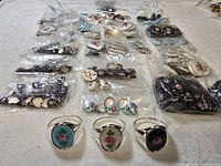 Assorted bags of floral cabochon inserts with three rings displayed