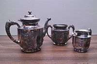 Three matching silverplate pieces: teapot, creamer, sugar bowl
