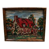 Front view of framed needlepoint showing cottage landscape motif and frame