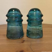 Both Hemingray-9 aqua glass insulators front view