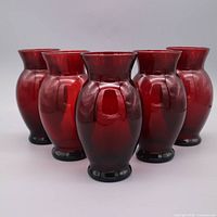 Group shot of five ruby red vases