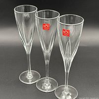 Three RCR crystal champagne flutes front view