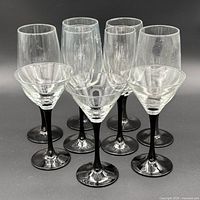 Group shot of eight glasses: six wine, two martini