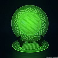 Two uranium glass plates glowing under UV light on stand