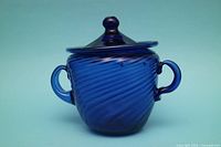 Front view of cobalt blue sugar bowl with lid and handles