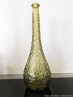 Full view of olive hobnail genie bottle standing upright