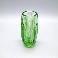 Angled view showing rim and relief pattern of green glass vase