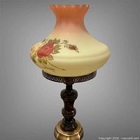 Full view of lamp showing shade gradient, wood column, brass base