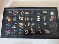Top view of display case showing multiple pairs of earrings