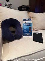 Neck pillow, elbow brace sleeve and boxed knee compression wrap on sofa