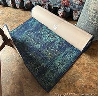 Rolled carpet runner partially unrolled showing pattern and edge binding