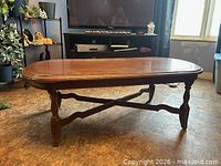 Full view of wooden coffee table showing legs and stretcher