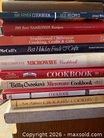Stack of nine cookbooks showing titles and spines