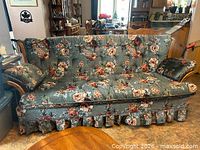 Front view of entire floral couch showing size and style