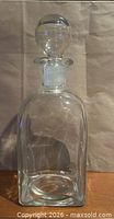 full view of clear glass decanter with stopper