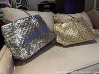Silver and gold metallic woven tote bags on sofa