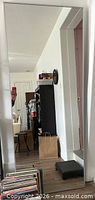 Front view of full-length mirror leaning against wall
