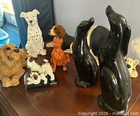 Group shot of all ceramic dog figurines on table