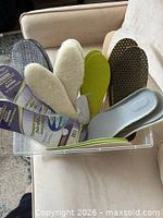 Bin with assorted insoles showing variety of colors and materials
