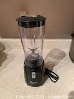 Full view of assembled black Betty Crocker personal blender on countertop